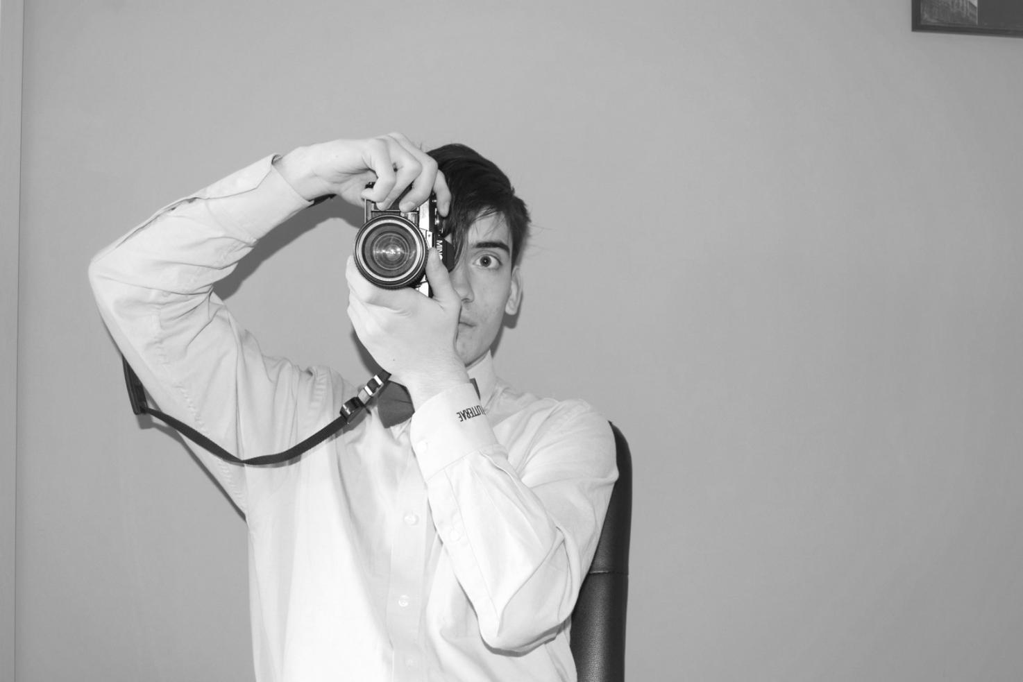 Photographer composing a shot in natural outdoor light